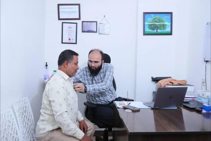 Dr. Khizer Hussain Junaidy examining a patient in his consulting room