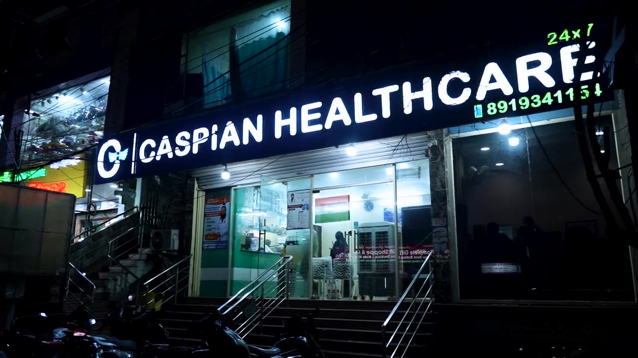 Caspian Healthcare at night, Vijay Nagar Colony, Hyderabad, with the entrance lit and the sign above it